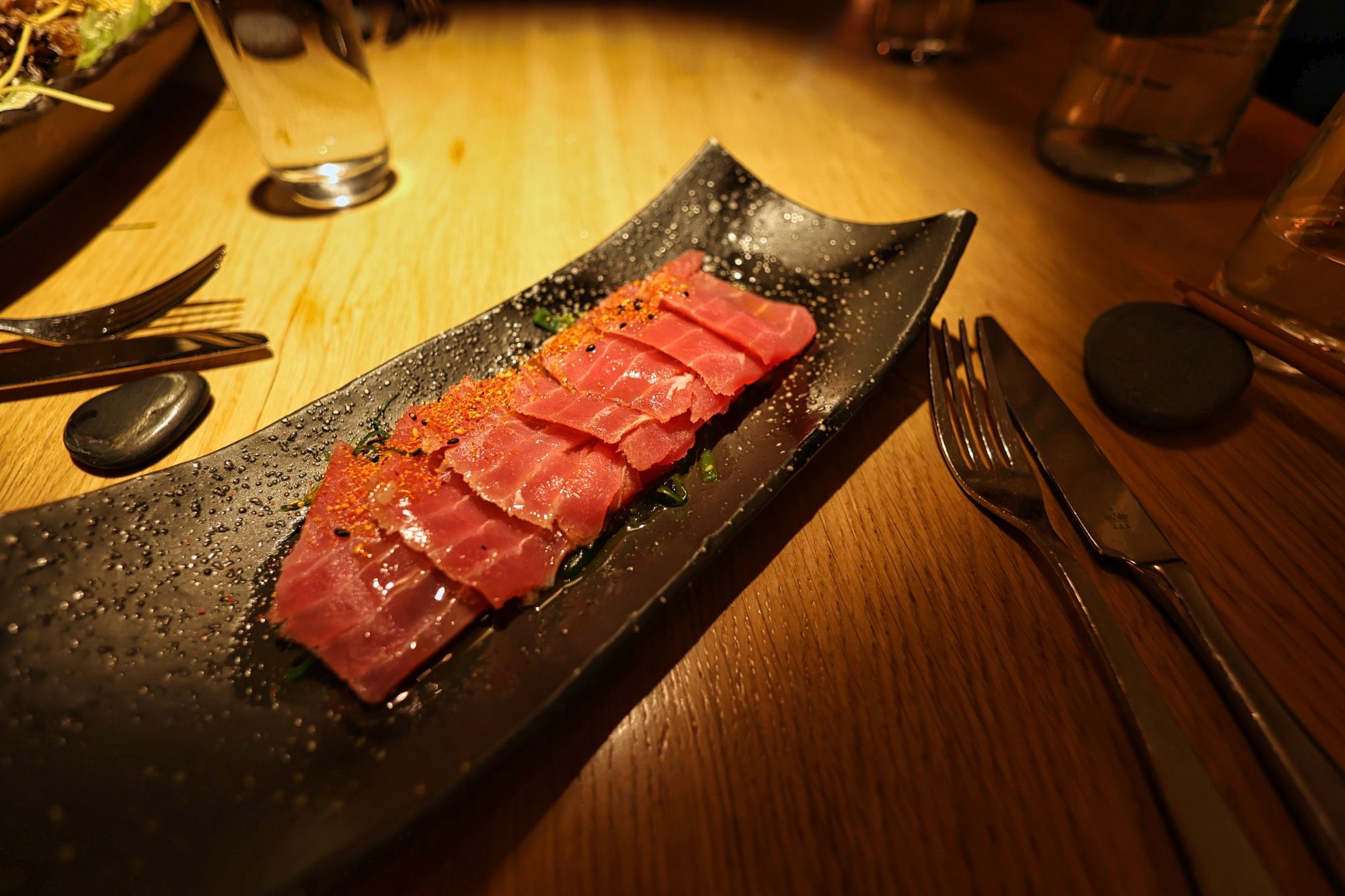 Tuna sashimi on a black plate